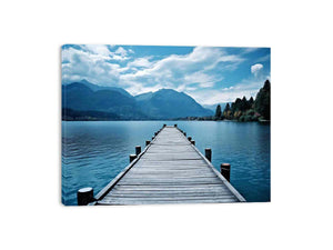 Calm lake jetty wall art with mountains for coastal living room decor.