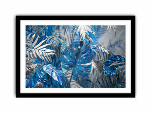 Blue tropical leaf canvas art with silver palm foliage for glamorous modern wall decor.
