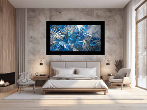 Blue tropical leaf canvas art with silver palm foliage for glamorous modern wall decor.