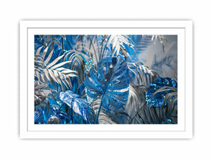 Blue tropical leaf canvas art with silver palm foliage for glamorous modern wall decor.