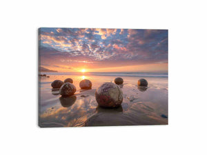 Coastal sunrise boulder canvas art for warm beach house and modern living room decor.