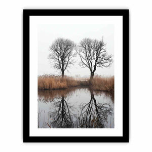 Misty winter trees reflected in still marsh water for serene vertical wall art.