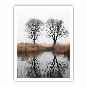 Misty winter trees reflected in still marsh water for serene vertical wall art.