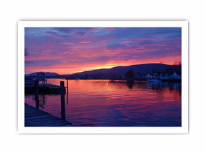 Sunset lake harbor canvas print with mountains and reflections for serene living room decor.