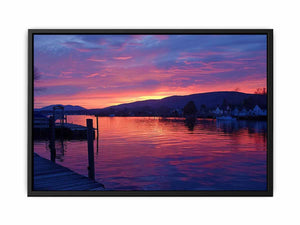 Sunset lake harbor canvas print with mountains and reflections for serene living room decor.