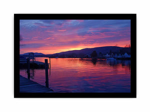 Sunset lake harbor canvas print with mountains and reflections for serene living room decor.