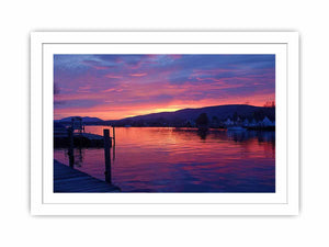 Sunset lake harbor canvas print with mountains and reflections for serene living room decor.