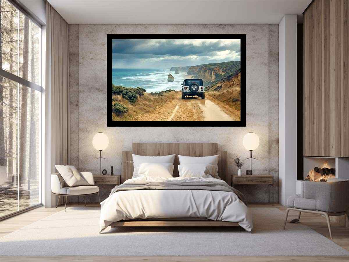 Off-road vehicle on a coastal dirt track overlooking turquoise waves, limestone sea stacks and golden cliffs beneath a cloudy sky