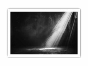 Dramatic black and white light beam entering a dark industrial room for modern living rooms decor.