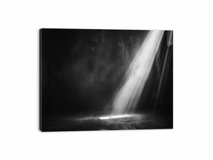 Dramatic black and white light beam entering a dark industrial room for modern living rooms decor.