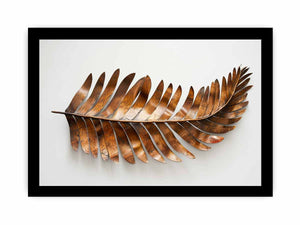 Metallic bronze palm leaf sculpture on a clean white background for modern living rooms decor.