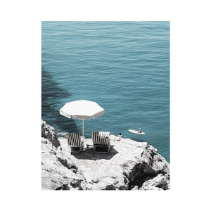 Coastal chairs overlooking calm sea for luxury beach house decor