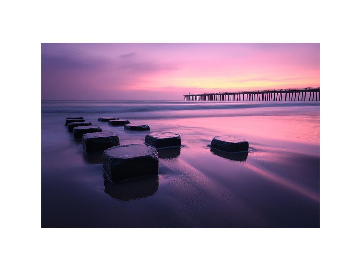 Pink sunset beach artwork with pier reflection for elegant bedroom decor