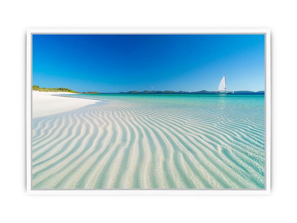 Tropical shoreline with sailboat and turquoise water for coastal living room decor