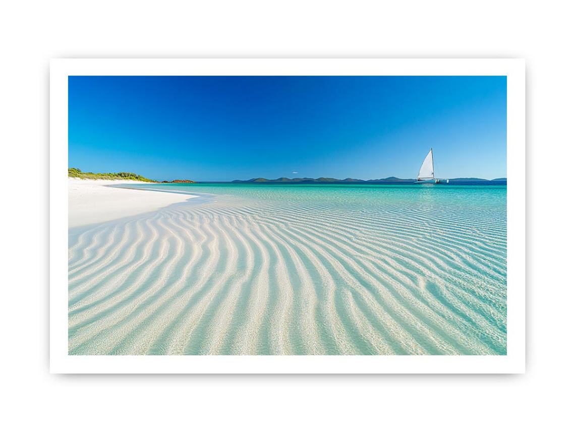 Tropical shoreline with sailboat and turquoise water for coastal living room decor