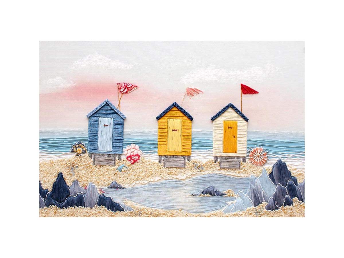 Colorful beach hut canvas art for cute coastal nursery decor.