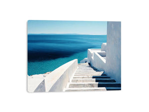 Mediterranean white stairs and turquoise sea canvas art for coastal living room decor.