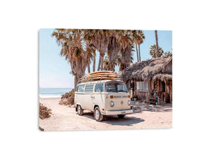 Cream vintage surf van near a palm beach hut for rustic coastal living room decor.