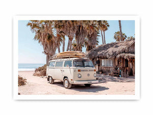 Cream vintage surf van near a palm beach hut for rustic coastal living room decor.
