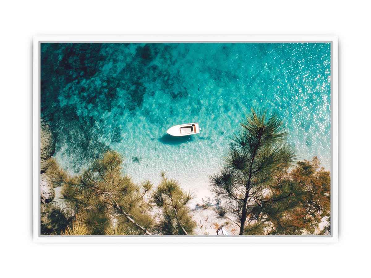 Aerial turquoise cove with white boat and pine trees for calming coastal wall art.