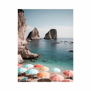 Pastel umbrellas overlooking turquoise sea cliffs for Mediterranean coastal bedroom decor.
