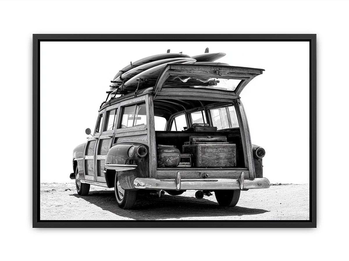Black and white rear view of vintage woody wagon with surfboards for coastal decor.