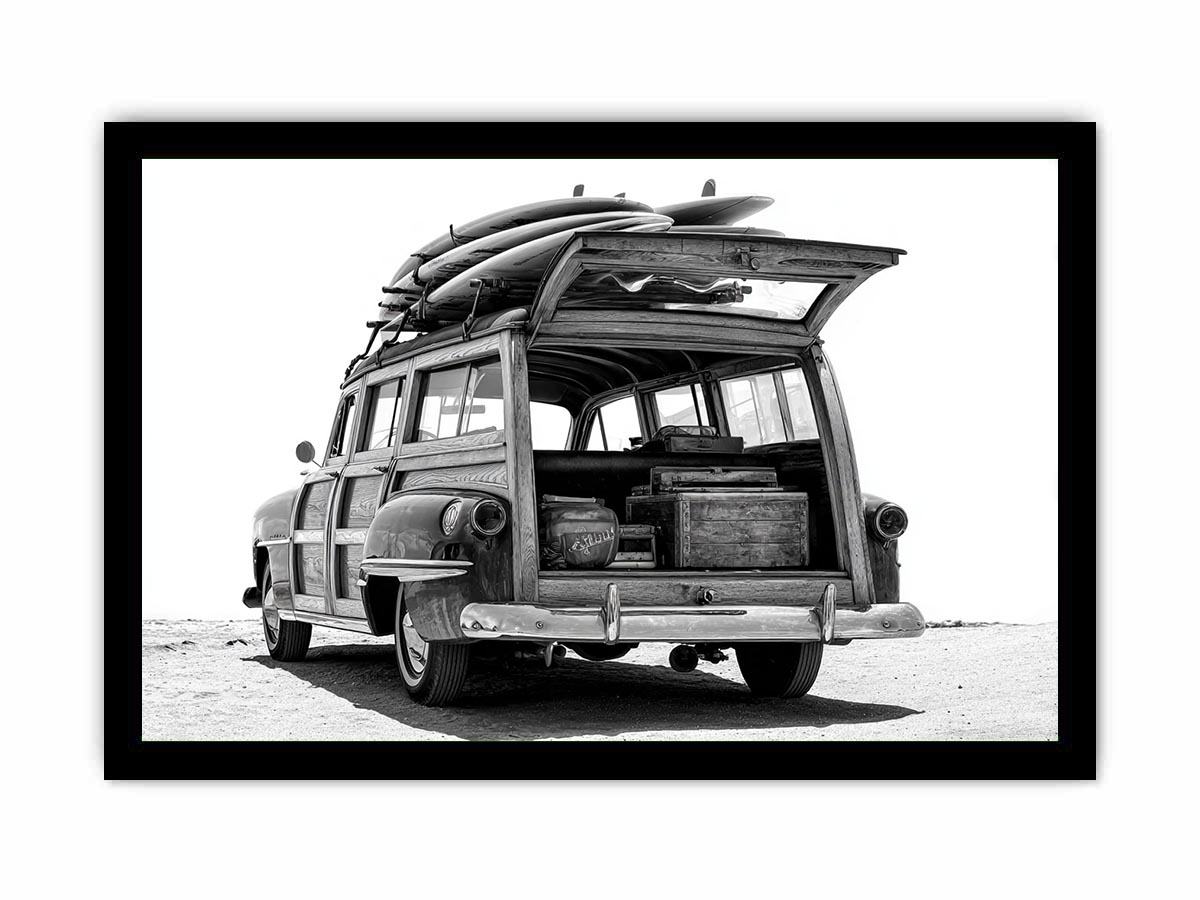 Black and white rear view of vintage woody wagon with surfboards for coastal decor.