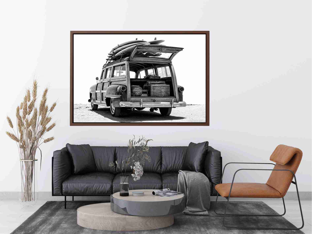 Black and white rear view of vintage woody wagon with surfboards for coastal decor.