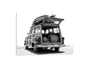 Black and white rear view of vintage woody wagon with surfboards for coastal decor.