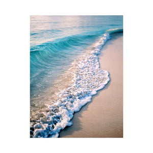 Soft turquoise ocean wave and sandy beach canvas art for coastal living room decor.