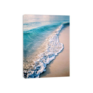 Soft turquoise ocean wave and sandy beach canvas art for coastal living room decor.
