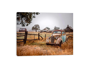 Weathered vintage car and rustic farm canvas art for farmhouse living room decor.