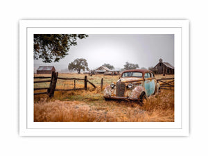 Weathered vintage car and rustic farm canvas art for farmhouse living room decor.