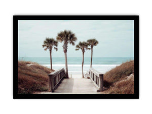 Coastal boardwalk with palm trees and ocean view for relaxed living room decor.