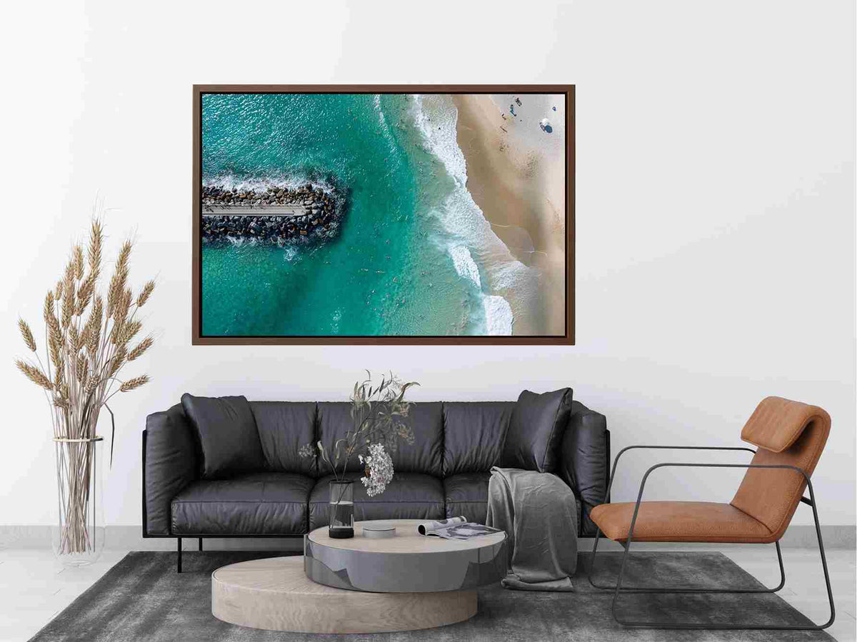Turquoise beach drone print with swimmers and rock jetty for coastal living room decor