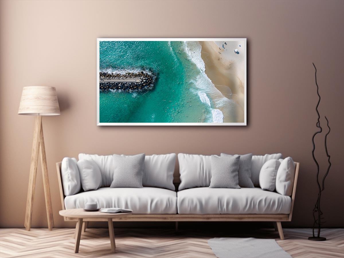 Turquoise beach drone print with swimmers and rock jetty for coastal living room decor