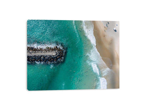 Turquoise beach drone print with swimmers and rock jetty for coastal living room decor