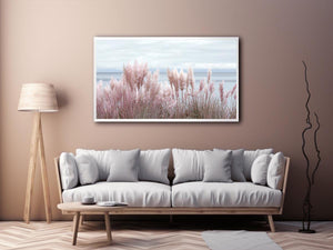 Soft blush pampas grass by the ocean as coastal botanical wall art for a serene bedroom.