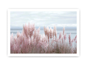 Soft blush pampas grass by the ocean as coastal botanical wall art for a serene bedroom.