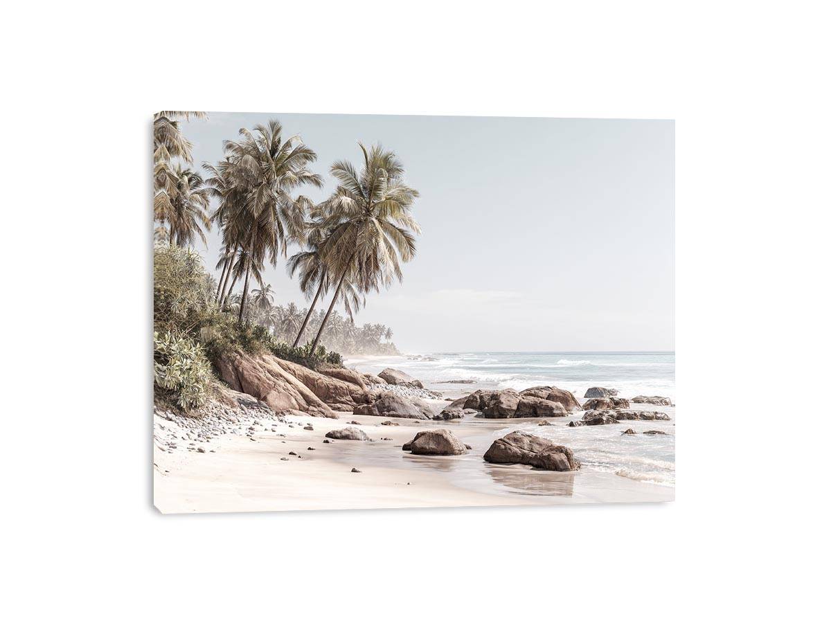 Coastal palm beach canvas photography with ocean and rocks for serene bedroom decor.