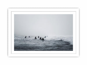 Moody surf canvas art with surfers and misty ocean waves for modern office decor.