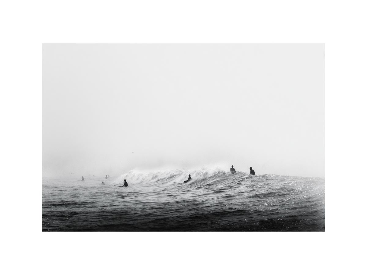 Surfers waiting on ocean waves artwork for coastal living room decor