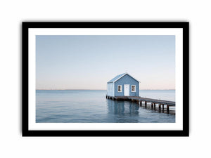 Blue boathouse over water artwork for coastal living room decor