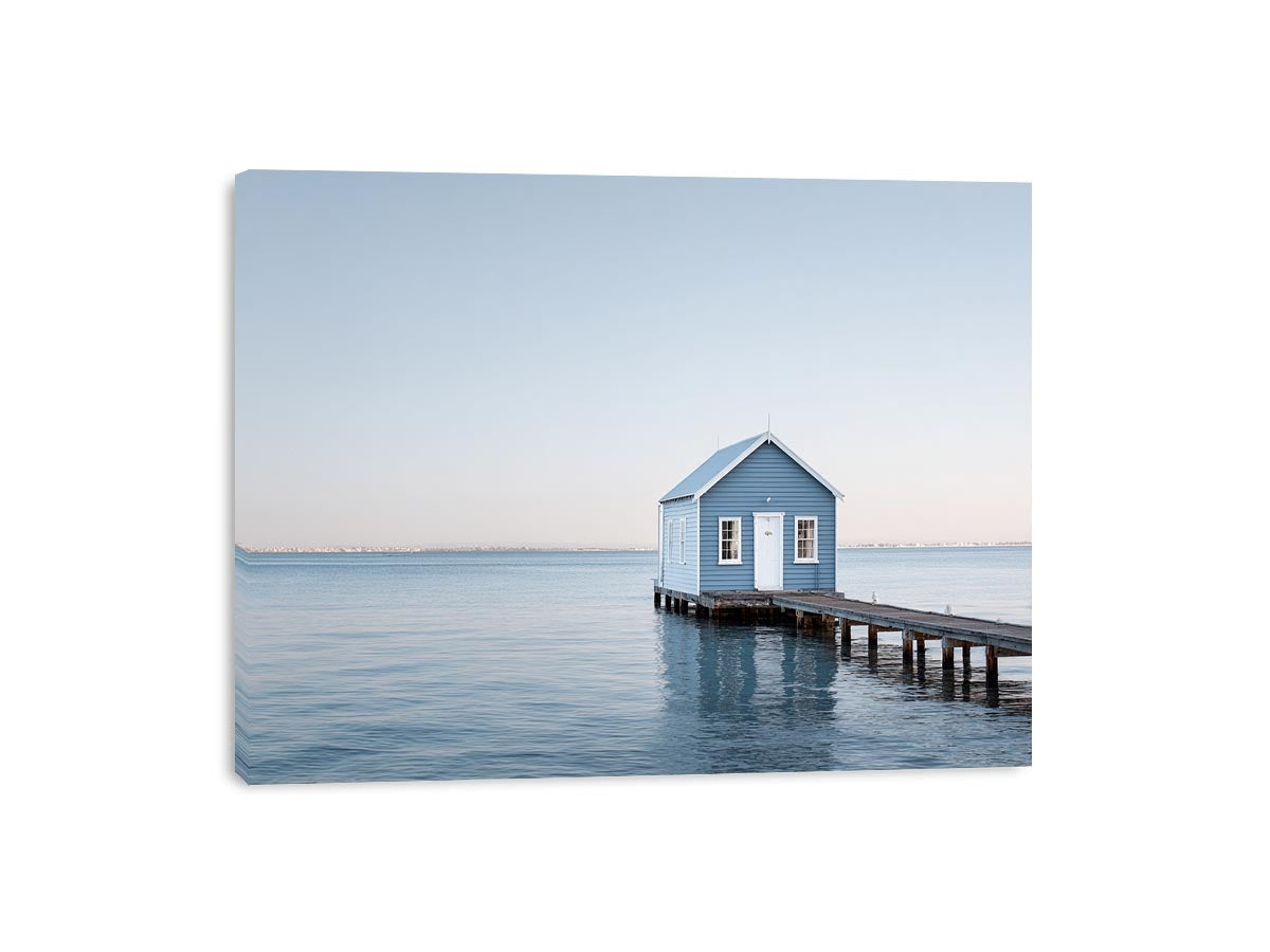 Blue boathouse over water artwork for coastal living room decor