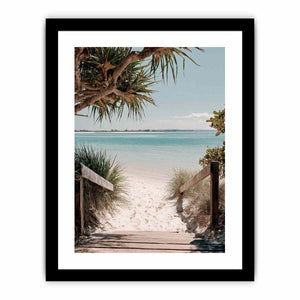 Beach pathway through dunes leading to a calm turquoise shoreline for coastal living room decor