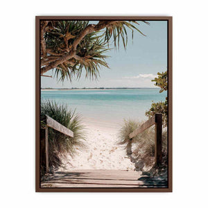 Beach pathway through dunes leading to a calm turquoise shoreline for coastal living room decor