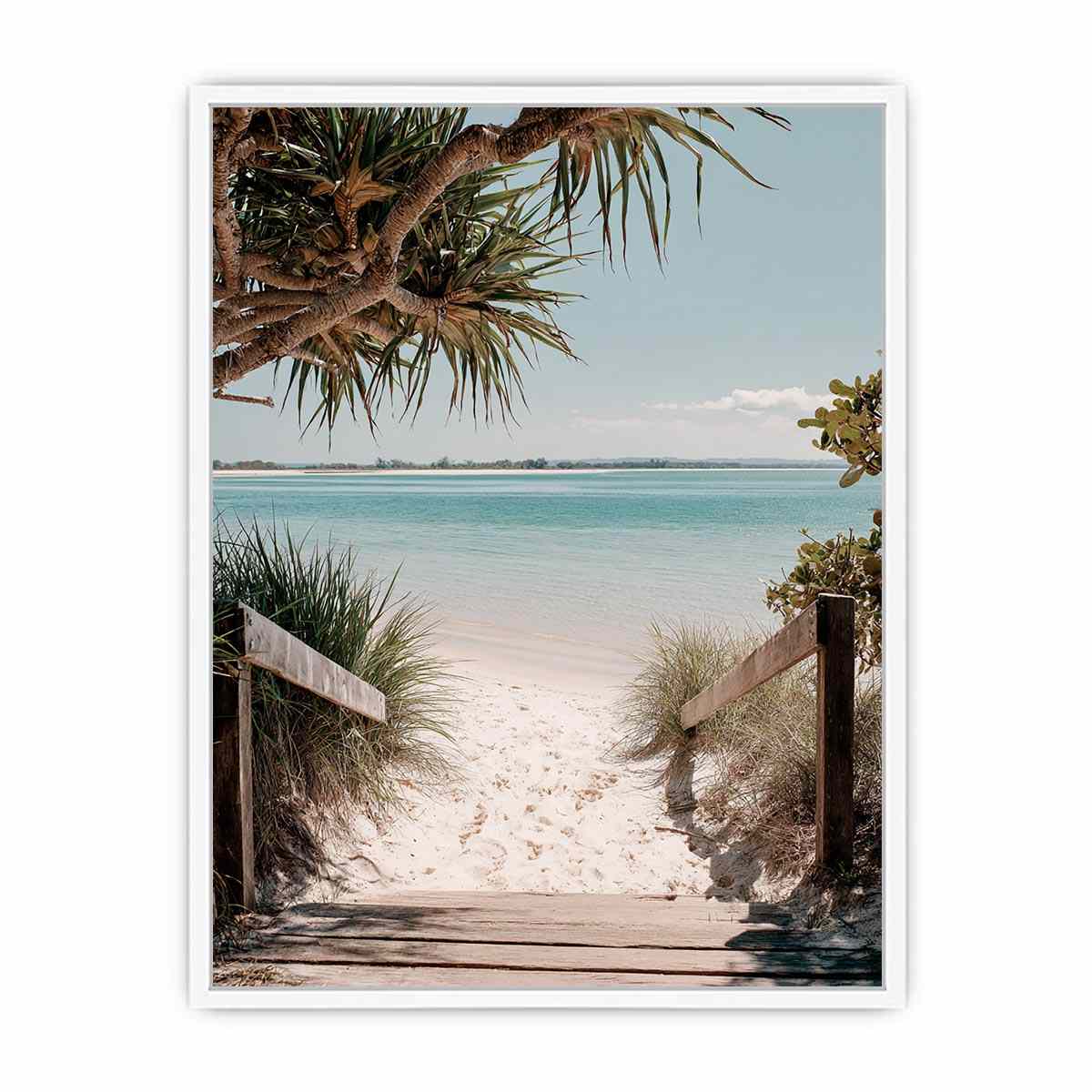 Beach pathway through dunes leading to a calm turquoise shoreline for coastal living room decor