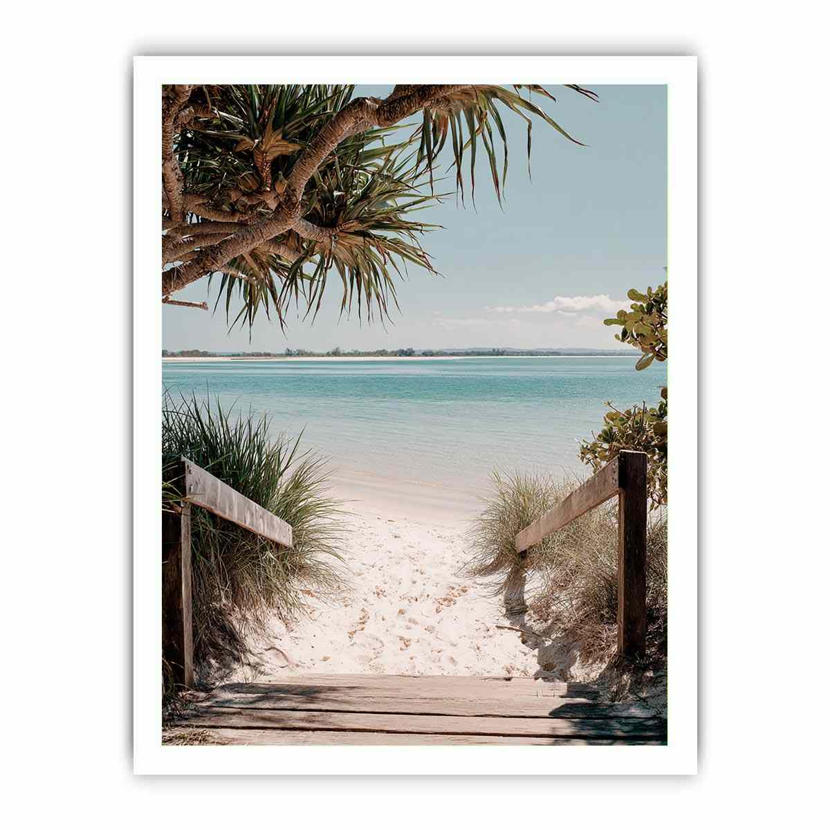 Beach pathway through dunes leading to a calm turquoise shoreline for coastal living room decor