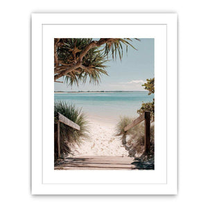 Beach pathway through dunes leading to a calm turquoise shoreline for coastal living room decor