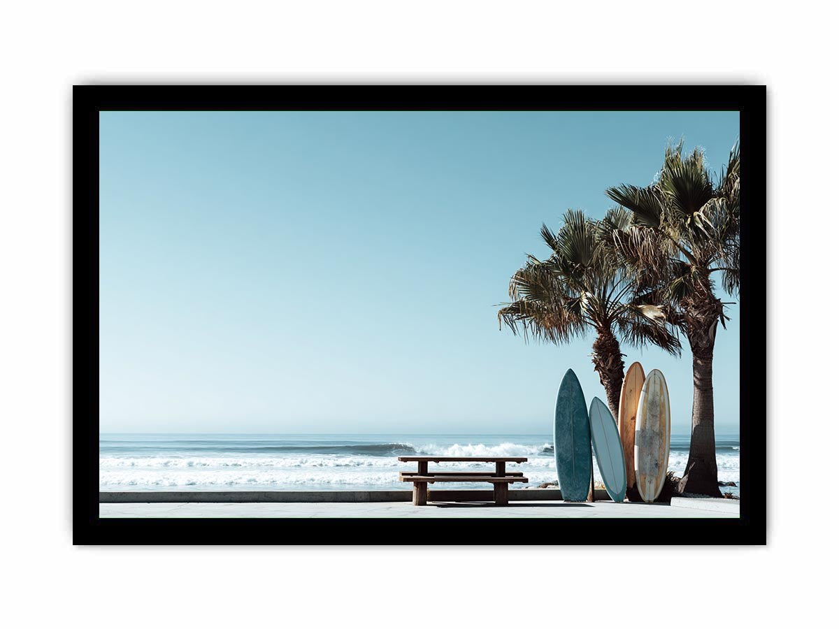 Surfboards and palm trees beside the ocean in coastal modern beach house decor